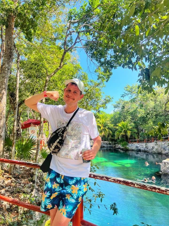 Jimmy beside a clear-water cenote
