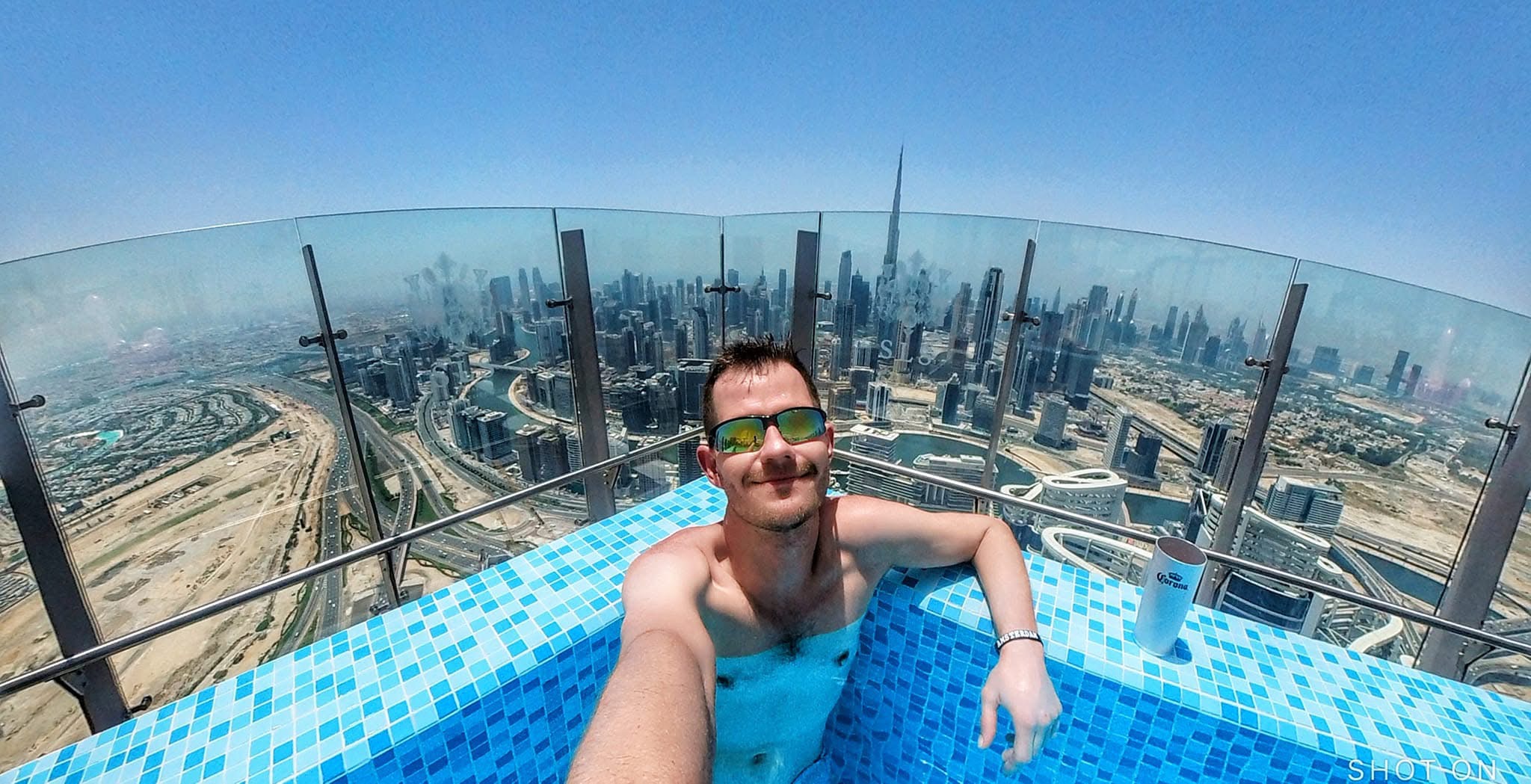 Jimmy in a rooftop pool above the Dubai skyline
