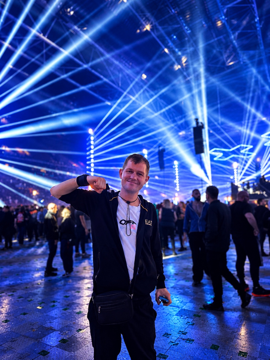 Jimmy at a music event under blue laser lights